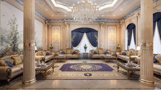 This picture shows a luxurious traditional living room interior design. The room is decorated with a cream-colored sofa in the center, surrounded by several royal blue chairs and two gold-and-black armchairs. The walls are painted a light beige color and decorated with several framed paintings. There is a large gold-painted mirror hung on the wall, and an illuminated crystal chandelier hangs from the ceiling in the center of the room. Furthermore, there is a wooden coffee table with silver candleholders and a subtle rug at the bottom to provide a warm and inviting atmosphere.