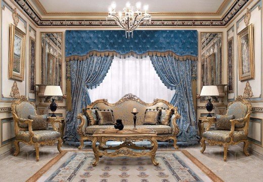 This picture shows a luxurious bedroom designed with modern decor. The walls are painted a neutral color, and the space is filled with dark furniture pieces. A four-poster bed with an intricate headboard is the focal point of the room, and it is adorned with plush pillows for comfort. A white chaise lounge is situated beside the bed, and two side tables provide a place for reading materials. In the corner of the room, an armchair and footstool provide a cozy nook for relaxing. The lighting in the room is soft, yet bright enough to ensure a comfortable