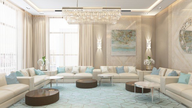 This picture shows an elegantly designed modern living room. The space features sleek white walls and floors, a large sectional sofa in light blue upholstery, two armchairs, two side tables, and a contemporary floor lamp. In the back of the room, an abstract art piece is displayed on a wall, adding a touch of color to the room. Behind the furniture, a broad arc window brings in natural light and provides an outdoor view.