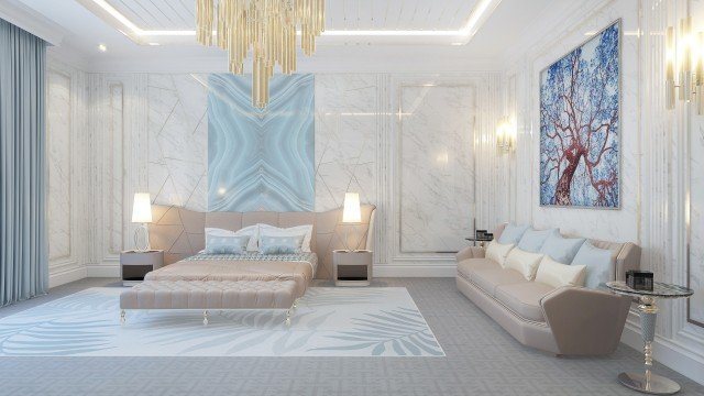 This picture shows a luxurious bedroom designed in gold and white. The room has an arched doorway, ornate chandelier, decorative columns, tufted headboard, and large windows. There is a cozy seating area with two white armchairs, a glass coffee table, and a white side table. An intricate rug on the floor adds to the elegance of the room.
