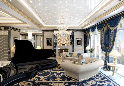 This picture shows an elegantly decorated living room. There is a large white sofa with several colorful pillows and a cream-colored sectional couch directly across from the white sofa. The walls are painted a light yellow, and there is a white fireplace at one end of the room. At the other end, a grand piano is positioned with a large wall mirror behind it. A crystal chandelier hangs from the ceiling, and two ornate side tables flank the sofa.