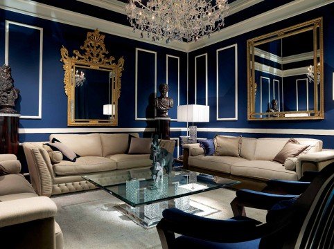 Luxurious modern living room with a velvet sofa, a chic crystal chandelier, and an ornamented ceiling that adds elegance.