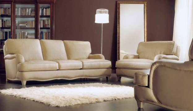 A beautiful, cozy corner with an elegant beige sofa, an eye-catching round table and a classy accessories.