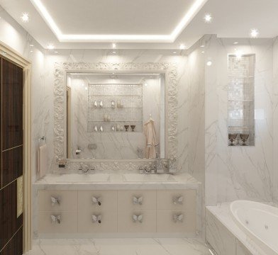 This picture shows a luxury bathroom in an opulent interior. The bathroom is decorated with white marble walls and flooring and a dark wood vanity with a large sink. On the wall there are several mirrors, a glass shelf, and a gold-detailed light fixture. The room is also decorated with white and blue flowers on the vanity and a round gold accent table.