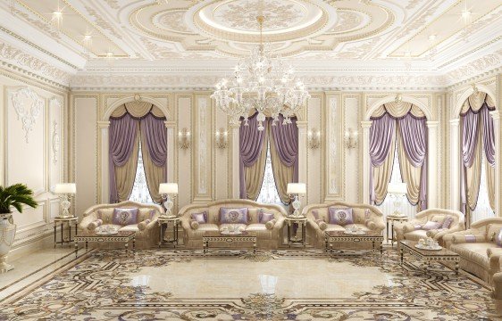 This picture shows a modern interior design of a luxurious living room. It features a grey velvet sofa and matching armchairs, a wooden coffee table, a white ceiling with recessed lighting, and an ornate crystal chandelier. The walls are covered in a textured stone patterned wallpaper with silver accents and a mirrored wall behind the seating area for added grandeur. There is also a flat-screen television on the wall and artwork depicting a landscape scene.
