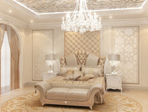 This picture shows an elegant and luxurious living space. The room has black and gold furniture, white walls, and a decorative archway. There are several comfortable seating areas around the room and an area rug in the center, allowing for a cozy, inviting atmosphere. The gold accents throughout the room create a sophisticated and glamorous look, which is further enhanced by the arched windows and crystal chandelier.