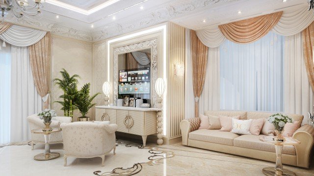 This picture shows a luxurious living room with traditional and modern elements. The walls are a light shade of brown, with ornate crown molding and recessed lighting. The room features a large sofa upholstered in a beige fabric, a wooden coffee table, a plush white rug, and floor-to-ceiling windows. Above the sofa hangs an elaborate crystal chandelier, while a smaller white fixture hangs on the wall to the right of the room. The decor includes an intricate wall sconce and an abstract painting. Overall, the room has a sophisticated and inviting feel