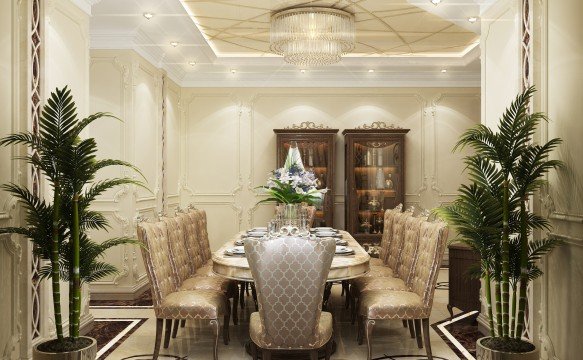 This picture shows a luxurious living room designed by Antonovich Design in the United Arab Emirates. The room features two cream-colored armchairs, matching cushions, and a gold and white patterned decorative carpet. A large glass coffee table is adorned with an intricate floral centerpiece. The walls are lined with an elaborate floral wallpaper, adding a touch of grandeur to the room. The room is illuminated by a crystal chandelier, as well as wall sconces positioned on either side of the sofa.