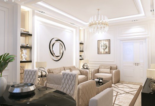 This picture shows a luxurious interior design of a living room. It features elegant furnishings, including a custom sofa and armchair set upholstered in a dark navy fabric with gold accents, a white round coffee table in the middle of the seating area, and a crystal chandelier hanging from the ceiling. The walls are painted a light grey and feature abstract artwork on the walls. A larger area rug in a neutral colour anchors the seating area and adds texture to the space.