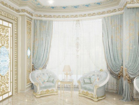 The picture shows a luxurious living room with classic furniture. The high ceiling, chandelier and fireplace add to the charm of the room. The walls are decorated with paintings and custom designed wallpapers. An ornate mirror on one side of the room and floor lighting provide an elegant atmosphere. There is an ottoman in the center of the room and two chairs on either side with a patterned rug between them. A glossy coffee table completes the look.