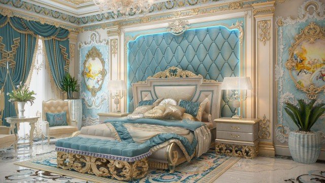 This picture shows a beautiful, luxurious, and spacious bedroom suite. The room features a luxurious four-poster bed with cream and gold bedding, two cream-colored armchairs, and a large mirror. The walls are decorated with printed wall portraits and a small chandelier hangs down from the ceiling. The overall effect is one of luxury and comfort.