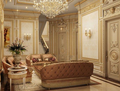 This picture shows a luxurious home interior design. The main focus is on the curved, beige-colored sofa that is placed in the center of the room and is decorated with luxurious, gold-colored cushions. The walls are painted a pale yellow color, and the floors have a dark brown stone tile. There is also an ornately decorated fireplace within the room and several pieces of artwork hung above it. In addition, there is a beautiful grand piano to the side of the fireplace, and several tall windows allow for natural light to come in.