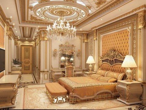 This picture shows a luxurious modern living room with gold, cream, and white accents. The walls are painted a light cream color, and the floor is tiled in an intricate pattern of black and white. A large, beige sofa is situated in the center of the room, with several cushioned chairs and ottomans surrounding it. On either side of the sofa are two tall windows, framed by white molding, and crystal chandeliers hang from the ceiling. To the left of the sofa stands a large, gilded mirror, and to the right is a glass-