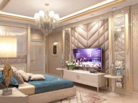 This picture shows a luxurious interior design of a living room. It includes a white sofa with gold-accented pillows, a white armchair with a gold footrest, and a glass top coffee table with intricate detailed legs. On the walls, there are colorful abstract artworks and a large gold-framed mirror, giving the room a regal atmosphere. The floor is covered in a light wooden parquet, and the ceiling has detailed white moldings, adding allure to the already opulent space.