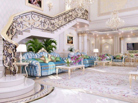 This picture shows an elegant living room designed by the experts at Antonovich Design. The room has a luxurious and sophisticated aesthetic with a luxurious white chaise lounge in the center and a chic black armchair to the right. An intricate, white pendant light hangs above the seating area and is framed by two large paintings on the wall. Light colored marble covers the floor and the walls have a subtle texture with a hint of gold. The room also has multiple windows, providing a lot of natural light.