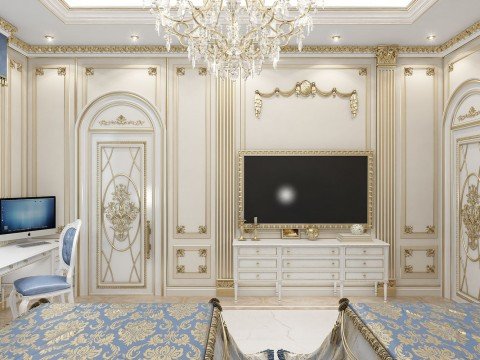 This picture shows an elegant, modern living space with a beige sofa set and ornate tables that feature intricate gold detailing. The walls are decorated with a beautiful floral pattern wallpaper and are accented with a large gold framed mirror. The flooring is finished in white marble and there is a balcony overlooking the city below.