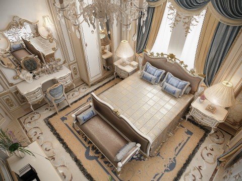 This picture shows a luxurious living room with a white marble tiled floor and a curved light beige sofa. The walls are covered in a light beige wallpaper, and a tall window is to the right of the sofa, allowing natural light to enter the room. A large crystal chandelier hangs from the ceiling, and the walls are decorated with dark green wall sconces and mirrors. A round glass side table sits between two white accent chairs, and a small green potted plant is placed on top.