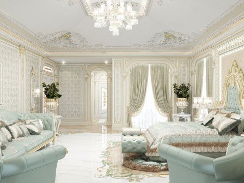 This picture shows a luxurious bedroom with two beds, a seating area, and a fireplace. There is a textured cream and beige wallpaper with matching curtains and bedding. A large window overlooks a garden with trees and flowers. The walls are decorated with modern art pieces and the room is illuminated by a large round chandelier.