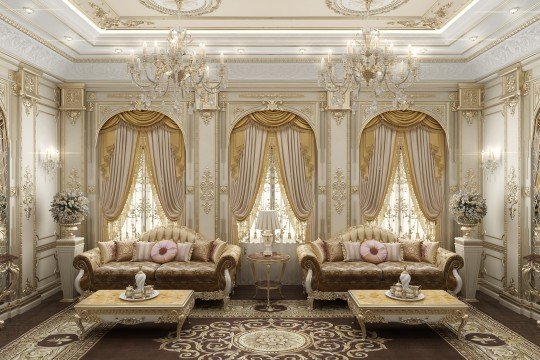 This picture is of a large, luxurious living space that features a white and gold color palette. The walls have been paneled with white leather and the ceiling has ornate gold trim. In the center of the room is a stunning crystal chandelier that hangs from the vaulted ceiling. The floor is covered in a plush white carpet and there are several ornately decorated sofas arranged in a semi-circle around the fireplace. There is also a grand piano in the corner of the room and some artwork hung on the walls.