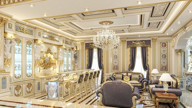 This picture shows a luxury living room with soft, beige furnishings and accents of gold. There is a large, comfortable looking sofa which has been upholstered in beige velvet fabric, along with multiple matching armchairs and a coffee table. The walls are adorned with golden framed paintings and artwork. A sleek, contemporary fireplace is set into one of the walls and stands out against the beige colour scheme. There is also a unique hanging chandelier that adds to the glamorous feel of the room.