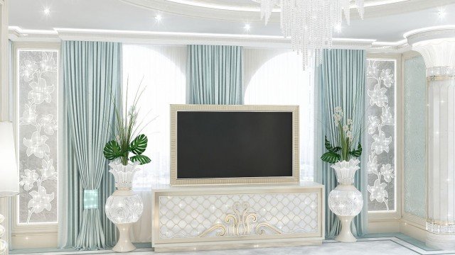 This picture shows a luxurious living room with a white marble floor and gold details. The room is decorated with a white chaise lounge and a glass coffee table. There are two beautiful white armchairs in the corner, and a large wall mirror hangs in the center of the room. A crystal chandelier hangs from the ceiling, adding a touch of elegance to the room.