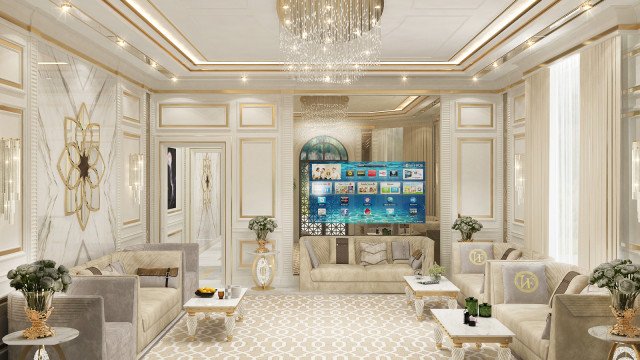 The picture is of a modern living room with white walls and ceilings. The walls are adorned with abstract art pieces and a mirror. The room has a large beige colored sofa with a few pillows on it. There is a coffee table with a glass top in front of the sofa, along with a couple of side chairs. On the far wall there is an entertainment unit with a TV and several shelves. The floor is covered in a light gray carpet and there is a large potted plant near the window.