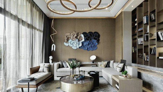 Modern apartment interior with furniture pieces, including tufted sofa and armchair in beige upholstery, glass coffee table, neutral rug and wall art.