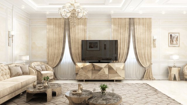 This picture shows a modern and luxurious living room designed in a contemporary style. The room features sleek white furniture, a black velvet Chesterfield sofa, a large abstract painting on the wall, two geometric-shaped side tables, and a sleek glass coffee table decorated with a flower bouquet in a silver vase. The room is illuminated by several recessed lights, creating a warm and inviting atmosphere.
