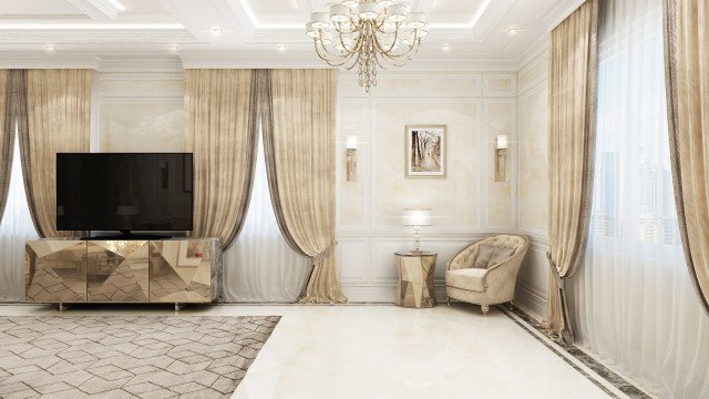 This picture shows a modern, luxurious bedroom with a high vaulted ceiling. There are two large windows on the left side of the room, with cream drapes pulled to one side. The floor is covered in a light beige carpet. A large four poster bed stands against the opposite wall, next to a dresser with a large mirror and a chaise-lounge. A seating area with an upholstered cream sofa and two armchairs occupies the far corner of the room. Two tall lamps with white shades stand in front of the windows.