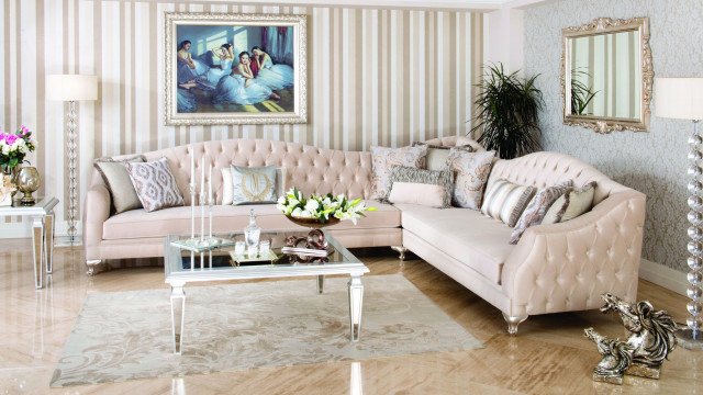 Modern living room with white furniture, dark wood floors, and two feature walls with accent wallpaper.