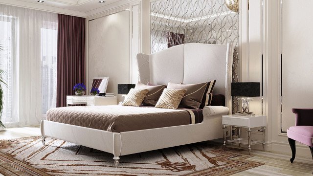 A bright, modern living room featuring cream-colored walls, white ceiling, beige tile flooring, and a stylish black sofa and armchair with various decorative pillows.