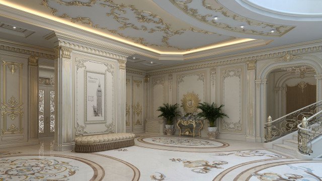 This picture is of a luxurious living room designed by Antonovich Design, a high-end interior design company. The room features a black and white marble floor, a light-colored wall with a mosaic art panel, an elegant white sofa and armchairs upholstered in a golden fabric, a unique gold leaf ceiling fan, and a beautiful crystal chandelier. The walls also feature golden wall sconces and several decorative artworks, while the area near the window is filled with lush green plants.