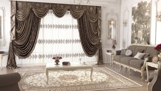 This picture shows a luxurious interior design with a white marble floor. There is a large sofa with decorative pillows and a beige armchair situated near a window. The walls are adorned with gold framed artwork and there is a chandelier and side lamps that give off a soft glow. Furthermore, there is a white rug and an oval shaped coffee table in the center of the room.