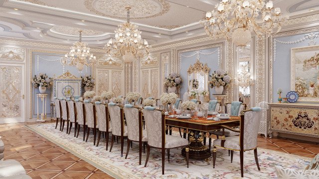 This picture depicts an ornate, luxury living room. The room has a lavish design made up of gold-colored accents, lush drapes, and plush furniture. An intricately designed chandelier is suspended from the ceiling, and two sets of floor-length windows provide natural light to the space. A cream-toned sofa takes center stage in the room, accompanied by a glass-top coffee table and two armchairs.