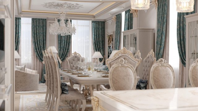 This picture shows a luxurious interior design of a dining room. The room features a large, elegant wooden dining table with chairs, ornate chandelier, and decorative wall sconces. A center piece of artwork is placed between the two doors. The walls are painted in a pale yellow color. The floor is covered with a patterned beige carpet and the window is framed in heavy burgundy curtains.