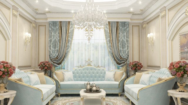 This picture shows a luxurious and modern living room designed by Antonovich Design. The room is decorated with a patterned gray and white wallpaper, elegant white furniture and decor pieces, and a light green center rug. The furniture includes a sleek black sofa, two rounded armchairs, accent tables, and a crystal chandelier. On the wall, there is a large mirror with gold detailing framed in black and white.