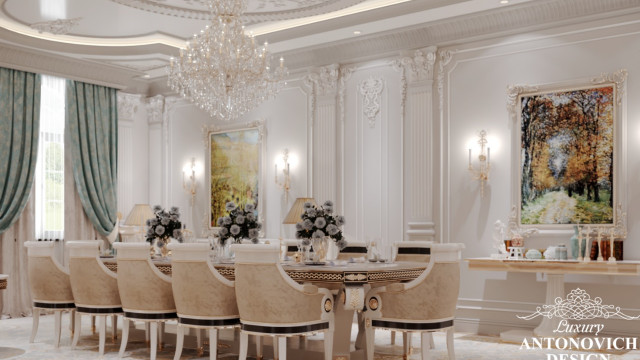 Interior featuring a luxurious set of furniture and decor, including a beige sofa, loveseat, armchairs, velvet pillows, and a grandiose chandelier.