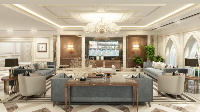 This picture shows a modern, spacious living room designed by Antonovich Design. The room has large windows which allow plenty of natural light to enter the space. There is a sectional sofa with several pillows and a matching ottoman resting against one wall. On the other side of the room is an accent wall with a large abstract painting that serves as the focal point. There are also two armchairs, end tables, and a round coffee table in the center of the room. The furniture is complemented by stylish decor and accessories.