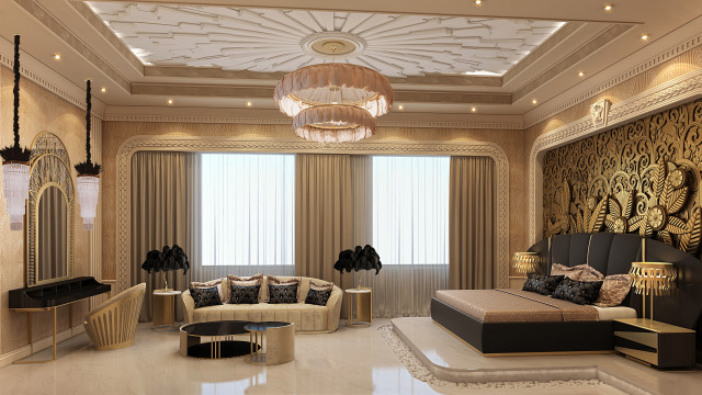 This picture depicts a luxurious and modern master bedroom. The walls are painted with a subtle cream color and adorned with gold accents throughout. The large bed is upholstered in a plush white velvet fabric and is accompanied by two distinct armchairs placed around a fireplace. The room features an ornate chandelier, mirrored nightstands, and several pieces of wall art that add a pop of character. The curtains are sheer and let in plenty of natural light, making this a cozy and inviting space for relaxation.