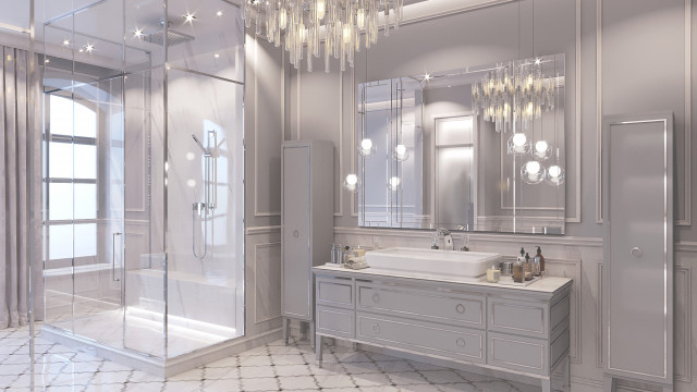 This picture shows an opulent bathroom in tones of white and gold. The bathroom features a freestanding soaking tub at the center surrounded by white and gold marble flooring as well as white walls with gold accents. In addition, it has a floating vanity with two sinks and LED-lit mirrors above them. There are also two luxurious gold arm chairs placed in each corner of the room, providing additional seating. Finally, the bathroom has a large window with views of the outside.