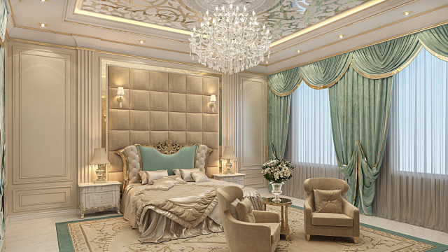 This picture shows a luxurious master bedroom with a large bed, accent walls and a modern ceiling. The space is decorated in muted colors, with white curtains, a beige velvet headboard, and accents of gold and silver to bring a hint of elegance. There are dark wood furniture pieces, such as a chest of drawers, side tables and a vanity. In the center of the room, there is an impressive chandelier that adds a touch of glamour.