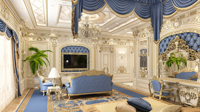 This picture shows a luxurious and modern interior design. The room features a large, curved sofa in a soft grey color with decorative pillows and a large, gold throw blanket. In the foreground, there is a contemporary glass coffee table with an elegant gold accent, and there is a unique, round gold mirror above it. The walls are white with a grey tile accent wall behind the sectional sofa and a feature wall with geometric wood panels. Additionally, the room is illuminated by two statement chandeliers and floor-to-ceiling windows that flood the space with natural light.
