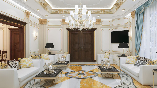 This image shows a contemporary interior design featuring a large white and beige living room with a detailed stone feature wall. There is a light gray rug and furniture arranged around a low coffee table, two armchairs with matching ottomans, and a navy sofa. Accent pieces such as a brass floor lamp, various decorative pillows, and a unique wall art piece are used to add interest to the space.