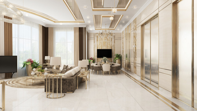 This picture shows an elegant and luxurious foyer. The walls are upholstered in a soft gray velvet fabric with modern lighting fixtures. There is a marble floor and stairs, with a gold railing leading to the second level and large windows that let natural light fill the space. A contemporary furniture set is placed to one side, and a glass door on the left leads to the exterior.