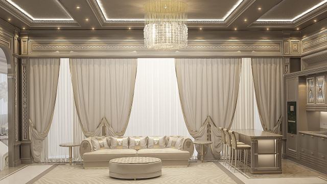 This picture shows a luxurious living room design with a high beamed ceiling, detailed crown molding, and a large chandelier. The walls are accented in soft shades of grey and gold, while the furniture is upholstered in a warm, cream colored fabric. There are two sofas and two armchairs arranged around a glass-topped coffee table, while a large Persian rug anchors the space. On the side tables, sconces, and art pieces add an extra layer of elegance to the room.