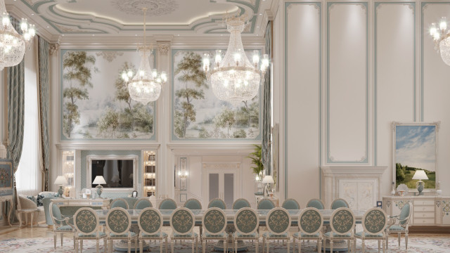 jpgThis picture shows an elegant and luxurious dining room. The walls are painted in a deep, rich grey color, and the ceiling has intricate gold detailing. There is a large round chandelier hanging from the center of the ceiling and the table is set up with white dinnerware and beautiful floral arrangements. The chairs feature ornate tufted backs with gold legs and there is a large ornate mirror on the wall. A colorful rug is placed underneath the table and two modern white floor lamps provide additional lighting.