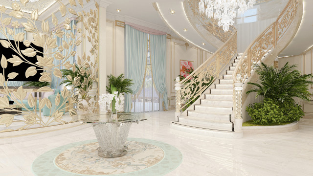 This picture shows a luxurious interior design featuring an elegant curved staircase with a gold and black balustrade. The walls are covered in ornately patterned wallpaper in shades of gold and green. The floor is inlaid wood, and a modern crystal chandelier hangs from the ceiling. On either side of the staircase, there are two tall and ornate vases filled with tall white flowers.