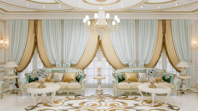 This picture shows a modern, elegant foyer with a marble floor, a grand chandelier, and two dark wood chairs. The walls are painted in a cream color, and the ceiling features decorative molding. A large, round mirror hangs on the wall between the chairs, adding an extra layer of sophistication to the room.