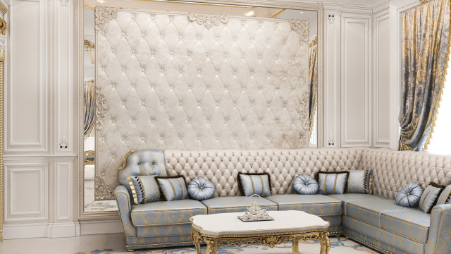 Interior design featuring an expansive white painted wall with an exquisite chandelier, a comfortable beige sofa, and a luxurious marble side table.