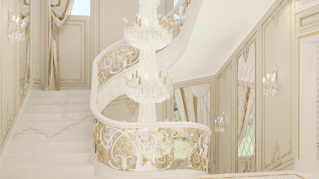 This picture shows a luxurious interior design. The focal point of the design is the grand staircase with its ornate detailing and classic white walls. The staircase is decorated with marble trim, intricate metal fences, and unique metal light fixtures. The stairs lead up to a large sitting area with plush furniture and a grand chandelier overhead. There are also several paintings and sculptures decorating the walls, adding to the sophistication of the room.